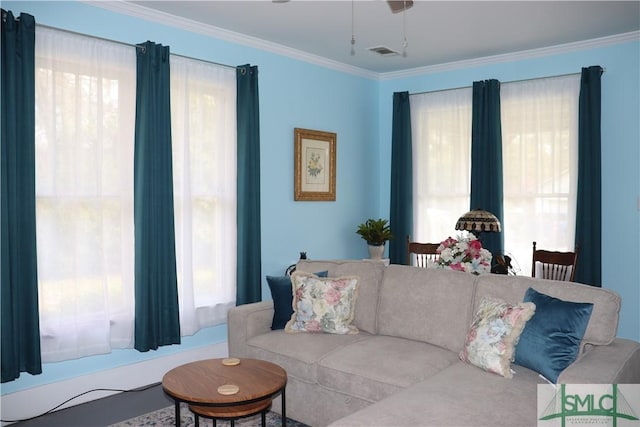 living area featuring visible vents and ornamental molding