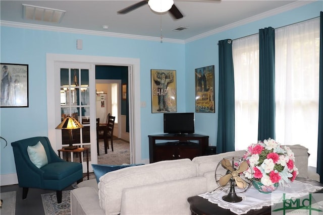 living area featuring crown molding, visible vents, and ceiling fan