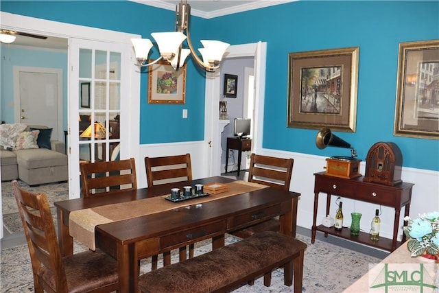 dining space featuring ornamental molding and a chandelier