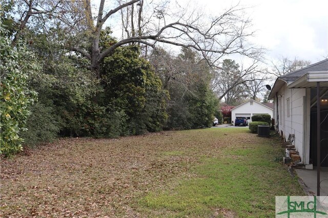 view of yard featuring cooling unit and a garage