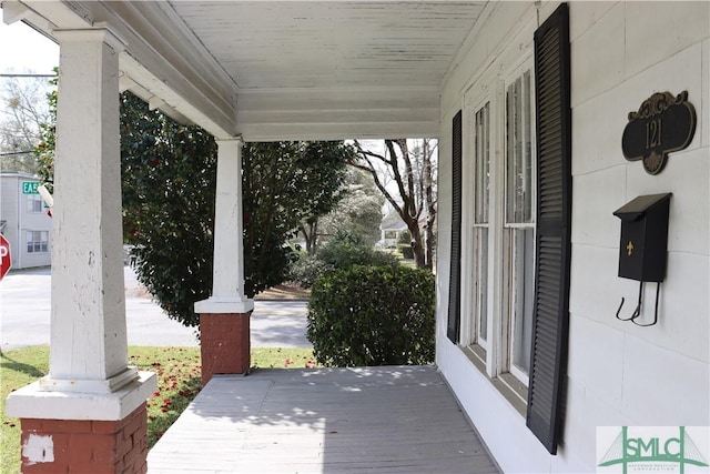 wooden terrace with a porch