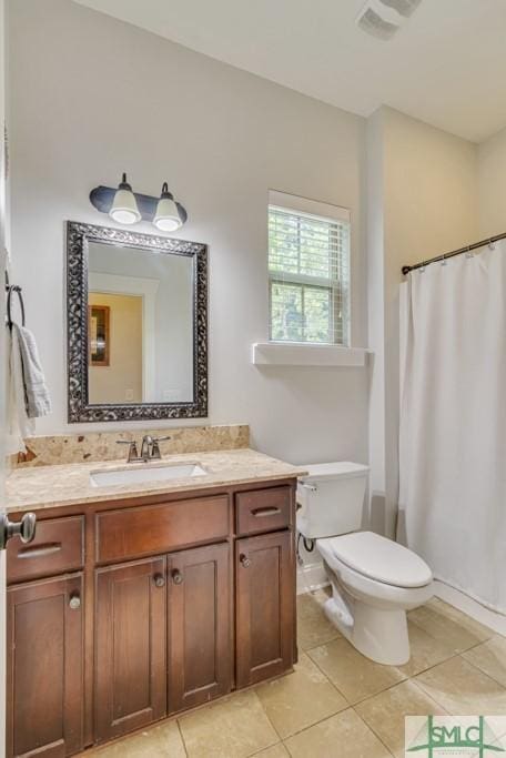 bathroom featuring visible vents, a shower with curtain, toilet, vanity, and tile patterned flooring