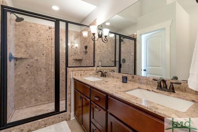 full bath featuring a shower stall, a chandelier, double vanity, and a sink