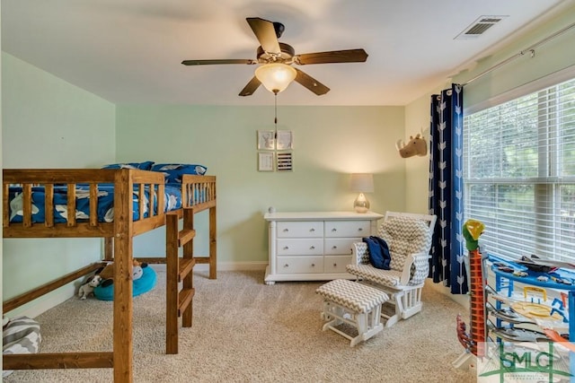 bedroom featuring visible vents, baseboards, ceiling fan, and carpet