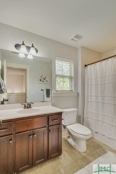 bathroom with vanity, tile patterned flooring, visible vents, toilet, and shower / bath combo