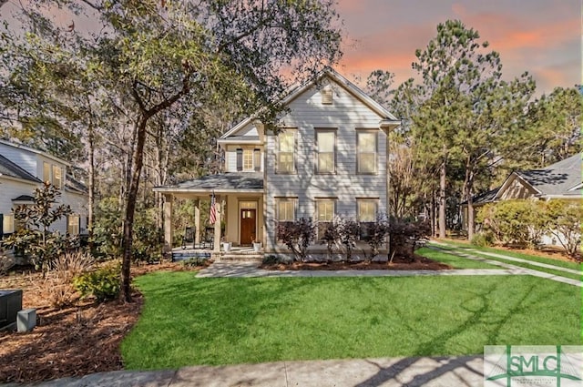 view of front of home with a front yard and a porch