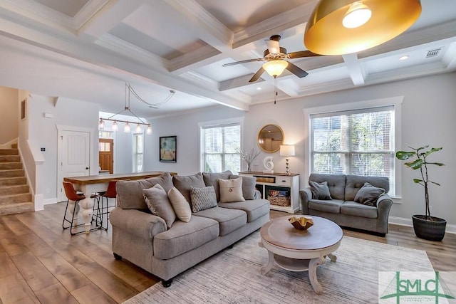 living area with beamed ceiling, visible vents, stairway, wood finished floors, and coffered ceiling