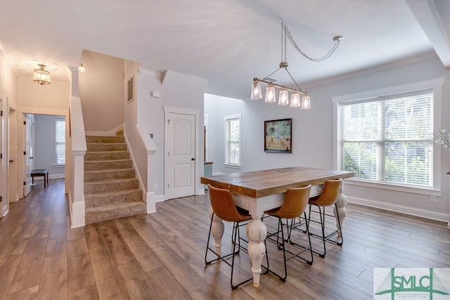 dining space with stairway, baseboards, crown molding, and wood finished floors