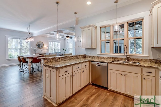 kitchen featuring a peninsula, pendant lighting, light wood-style floors, dishwasher, and a sink