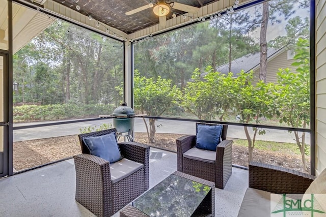 unfurnished sunroom featuring ceiling fan and plenty of natural light