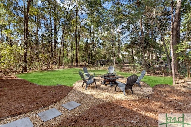 view of yard featuring a fire pit and fence
