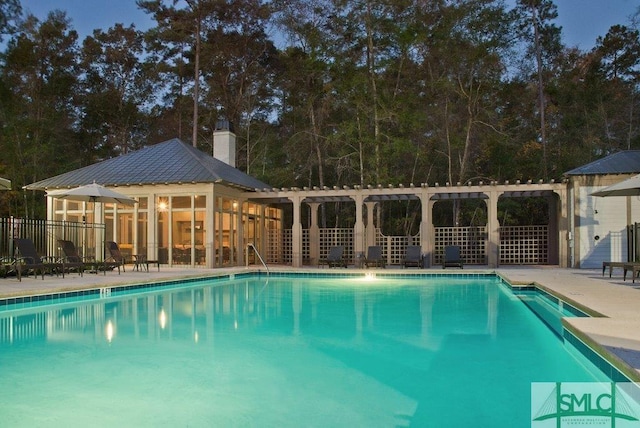 community pool with an outdoor structure, fence, a patio, and a pergola