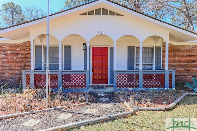 view of front of house with brick siding and a porch