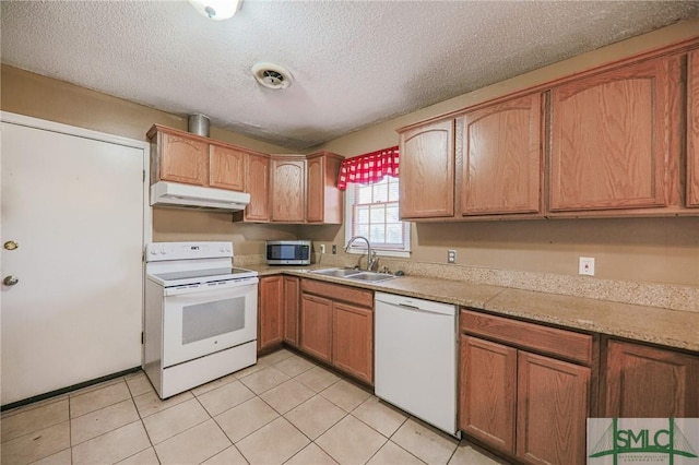 kitchen with a sink, white appliances, under cabinet range hood, and light countertops