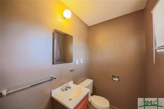 half bathroom featuring toilet and vanity