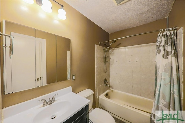 bathroom with toilet, vanity, a textured ceiling, and shower / tub combo