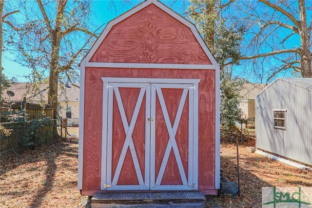 view of shed featuring fence