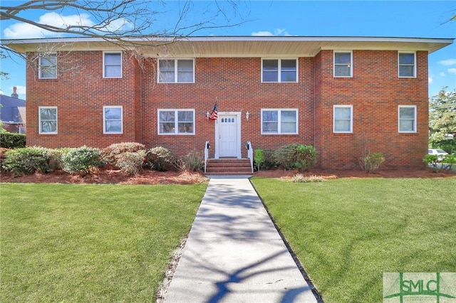 601 E 53rd St, Savannah, GA 31405 - view of front of house with a front yard and brick siding