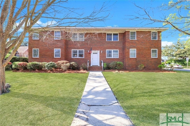 601 E 53rd St, Savannah, GA 31405 - view of front facade featuring a front yard and brick siding