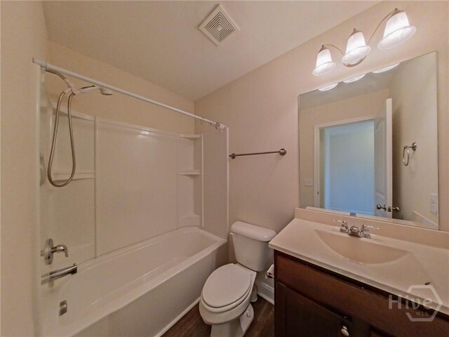 180 Kepler Loop, Richmond Hill, GA 31324 - bathroom with toilet, vanity, shower / tub combination, and wood finished floors