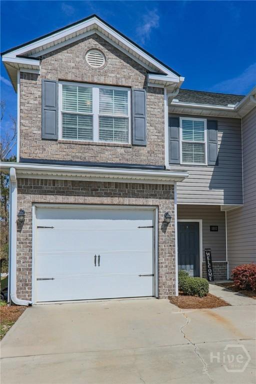 180 Kepler Loop, Richmond Hill, GA 31324 - view of front of property featuring an attached garage, concrete driveway, and brick siding
