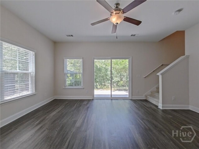 180 Kepler Loop, Richmond Hill, GA 31324 - unfurnished living room featuring dark wood-type flooring, baseboards, stairway, and a ceiling fan