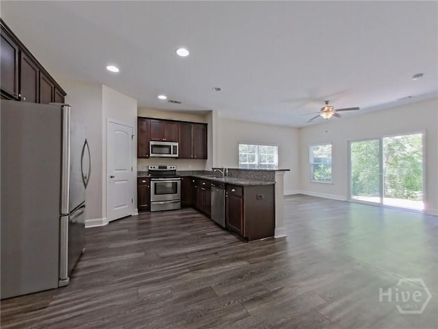 180 Kepler Loop, Richmond Hill, GA 31324 - kitchen with stainless steel appliances, baseboards, ceiling fan, dark brown cabinetry, and a sink