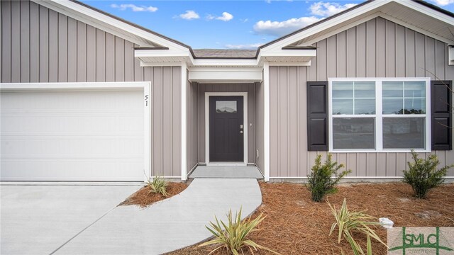 entrance to property featuring an attached garage
