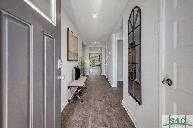 hall with baseboards and dark wood-style flooring