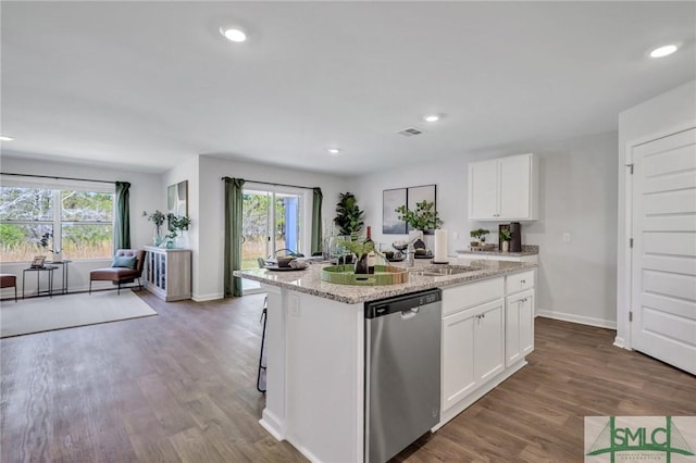 kitchen featuring stainless steel dishwasher, wood finished floors, visible vents, and a sink