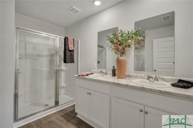 full bath with wood finished floors, visible vents, and a stall shower
