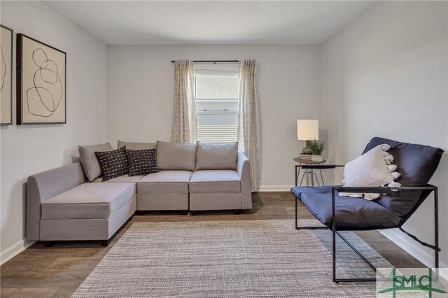 living room with baseboards and wood finished floors