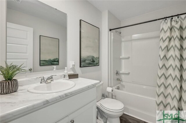 bathroom featuring toilet, vanity, and shower / bath combination with curtain