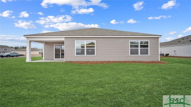back of property featuring a patio area and a lawn