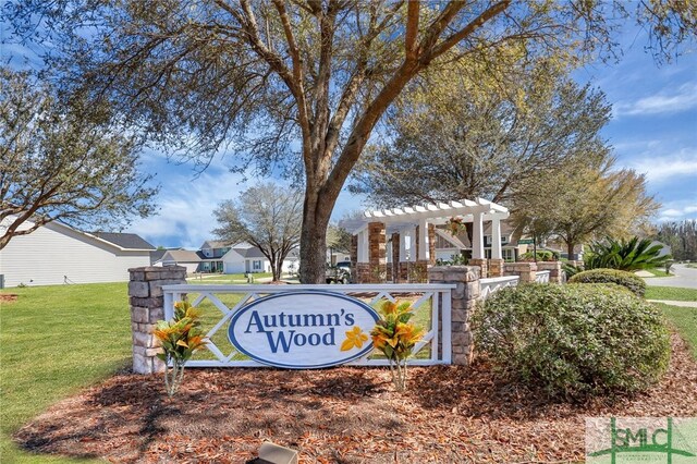 community / neighborhood sign featuring a lawn