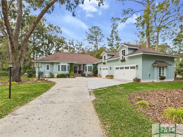 5 Flying Jib Ln, Savannah, GA 31411 - view of front of home featuring concrete driveway, a front lawn, an attached garage, and roof with shingles