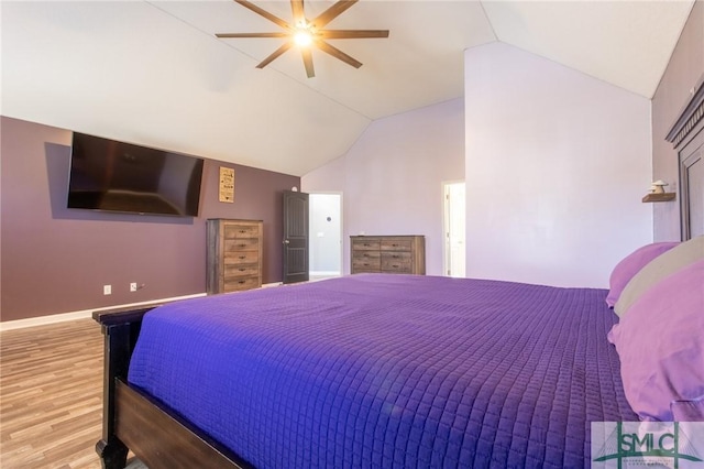 126 NE Owens St, Ludowici, GA 31316 - bedroom with lofted ceiling, baseboards, light wood finished floors, and ceiling fan