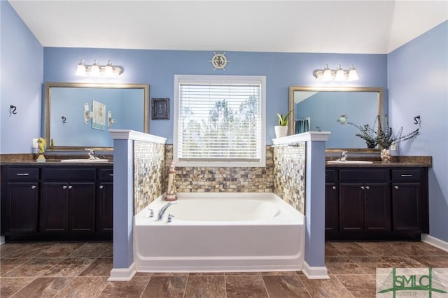 126 NE Owens St, Ludowici, GA 31316 - bathroom with a sink, a garden tub, and two vanities