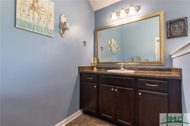 126 NE Owens St, Ludowici, GA 31316 - bathroom featuring baseboards, vanity, and tile patterned flooring