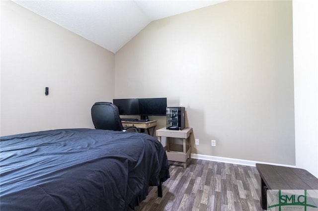 126 NE Owens St, Ludowici, GA 31316 - bedroom with vaulted ceiling, wood finished floors, and baseboards