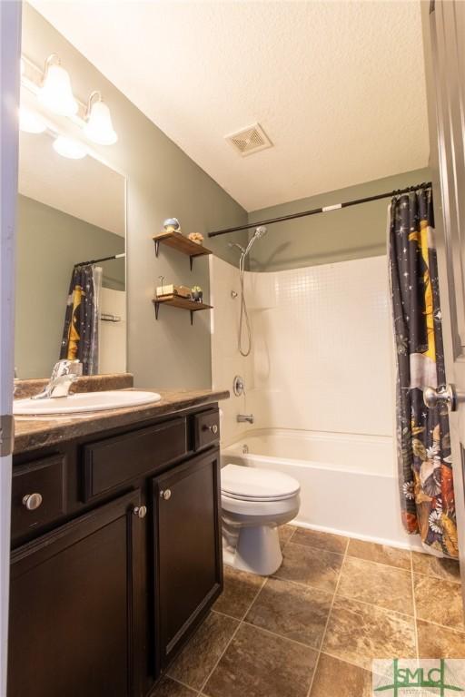 126 NE Owens St, Ludowici, GA 31316 - bathroom with visible vents, toilet, shower / tub combo, a textured ceiling, and vanity