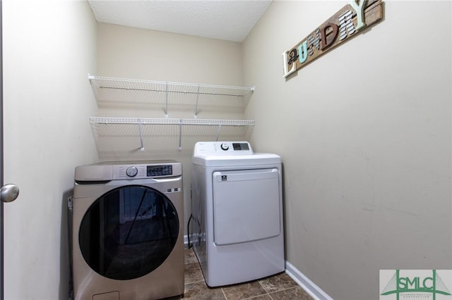 126 NE Owens St, Ludowici, GA 31316 - laundry area featuring a textured ceiling, laundry area, baseboards, and washing machine and clothes dryer