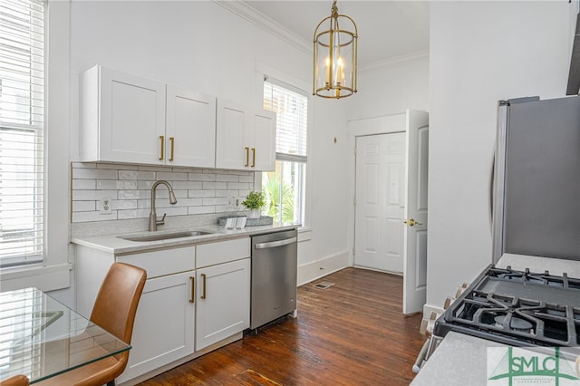 2210 Bull St, Savannah, GA 31401 - kitchen with stainless steel appliances, decorative backsplash, light countertops, a sink, and crown molding