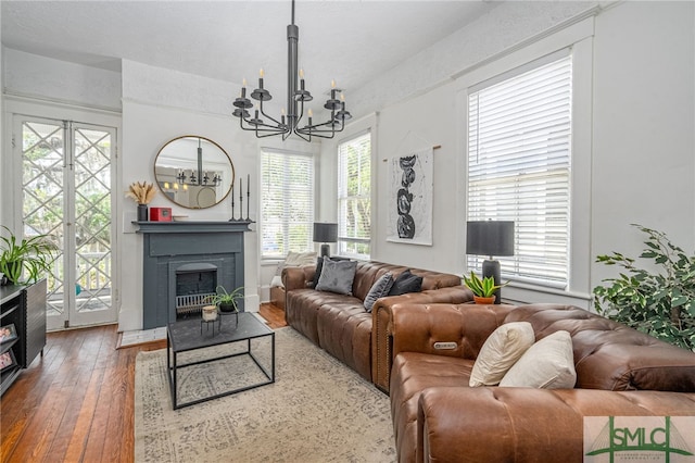 2210 Bull St, Savannah, GA 31401 - living area featuring a notable chandelier, a fireplace with raised hearth, and wood-type flooring