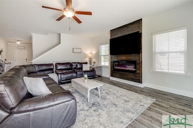55 Saddlebrush Rd, Ellabell, GA 31308 - living area with wood finished floors, a fireplace, a ceiling fan, and baseboards