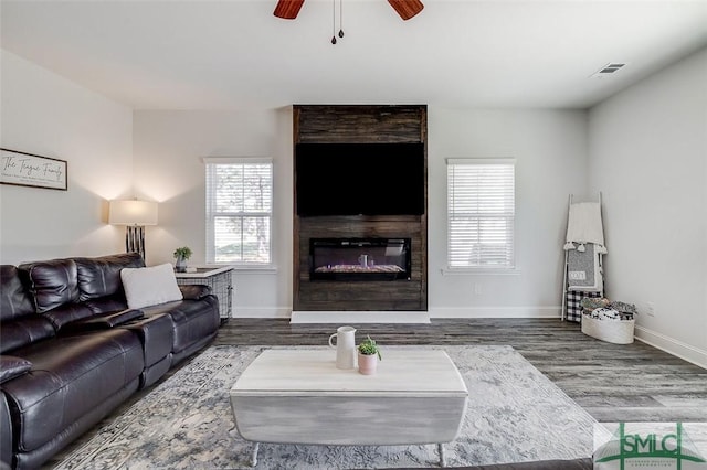 55 Saddlebrush Rd, Ellabell, GA 31308 - living room with ceiling fan, a large fireplace, visible vents, wood finished floors, and baseboards