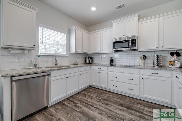 55 Saddlebrush Rd, Ellabell, GA 31308 - kitchen featuring backsplash, a sink, white cabinetry, and stainless steel appliances