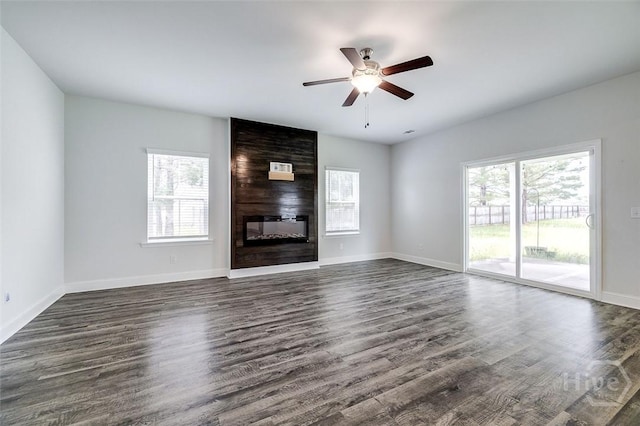 55 Saddlebrush Rd, Ellabell, GA 31308 - unfurnished living room featuring a ceiling fan, healthy amount of natural light, a large fireplace, and dark wood-style floors