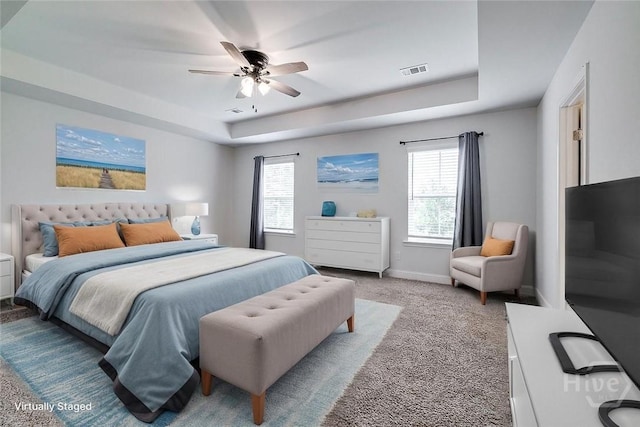 55 Saddlebrush Rd, Ellabell, GA 31308 - bedroom with a tray ceiling, multiple windows, light colored carpet, and baseboards