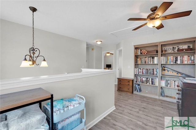 interior space featuring light wood-style floors and attic access
